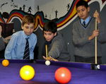 Some year 7's try out their newly recovered pool table in their Common Room.